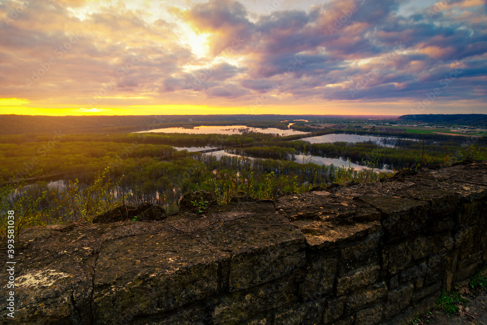 Landscape view from Wyalusing State Park by capture sunrise or sunset over the lake in cloudy day with old brick wall at foreground.