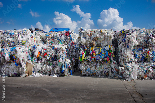 Bales of mixed post consumer bags and film from municipal curbside residential collection stacked in rows waiting to be marketed and processed in to usable resin