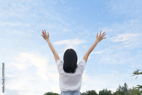 The woman relaxing and show her hand into the sky. Travel concept