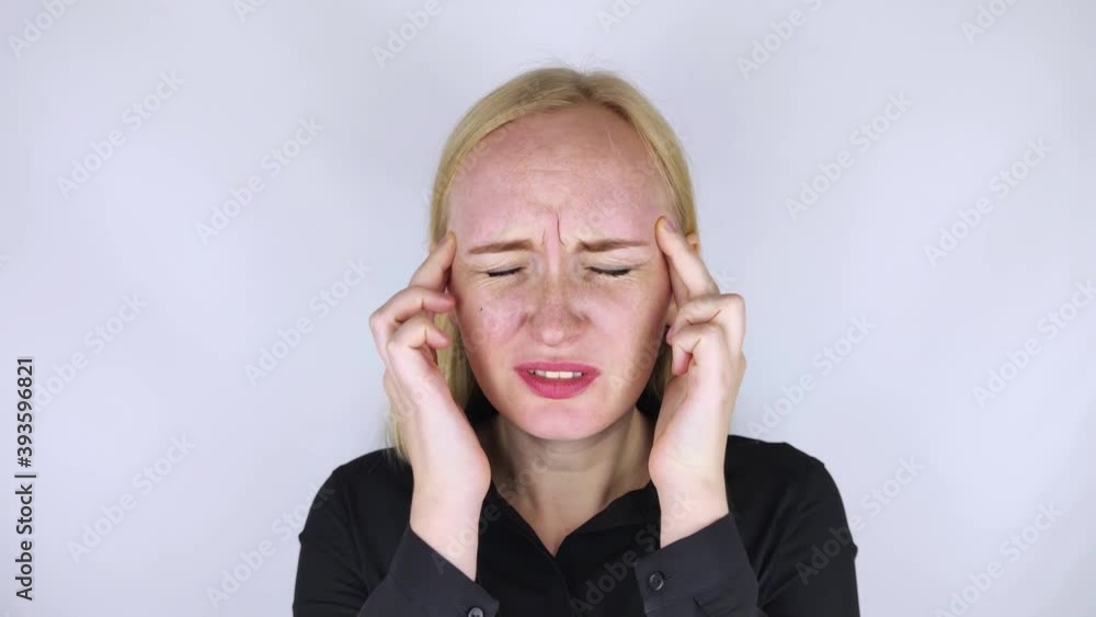 A woman holds his head with his hands. Sensation of headache, migraine and dizziness. Headaches from stress or overwork. On examination by a doctor. A woman holds his head with his hands. Sensation of headache, migraine and dizziness. Headaches from stress or overwork. On examination by a doctor.