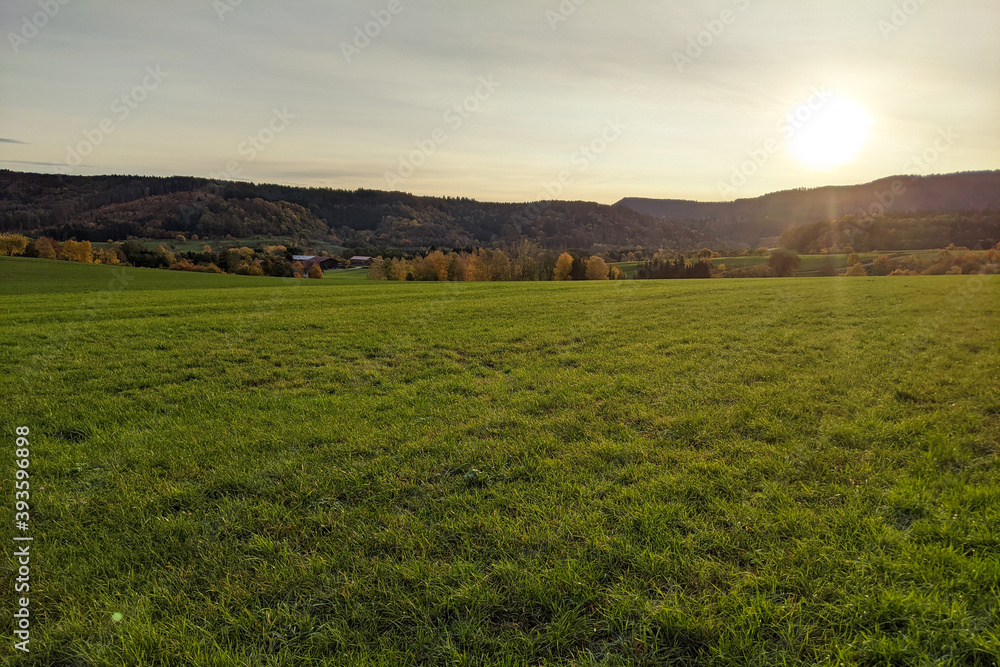 Fototapeta premium sunrise in autumn mountain with field view