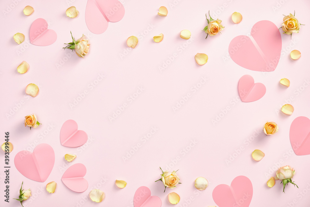 Happy Valentines day concept. Frame made of paper hearts, roses flowers petals and buds on pastel pink background. Flat lay, top view, copy space. Valentine day greeting card template, banner mockup.