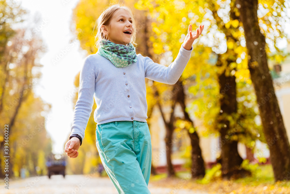 Happy childhood concept.Excited blond girl child play with bubbles outdoor in autumn city park. Happy childhood concept.Excited blond girl child play with bubbles outdoor in autumn city park.