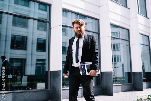 Wallpaper Mural Serious bearded businessman walking at office building Torontodigital.ca