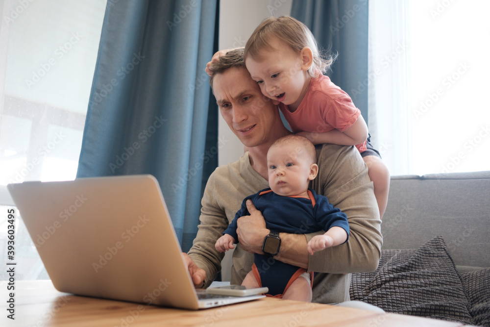 Stay at home father feeling tired while trying to work and babysitting his small daughter. Stay at home father feeling tired while trying to work and babysitting his small daughter.