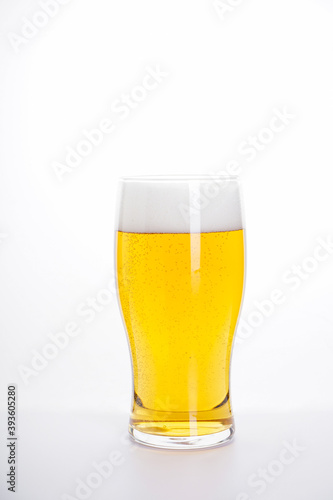 Glass of light beer on a white background