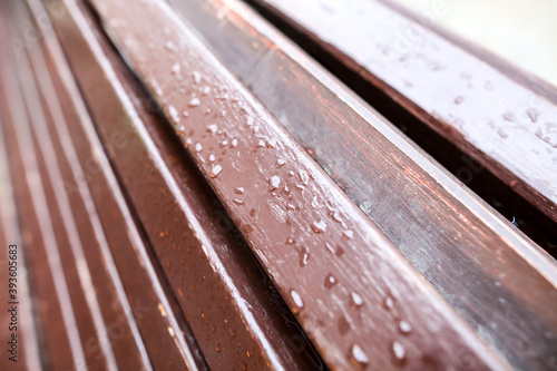 Raindrops on a wooden bench.