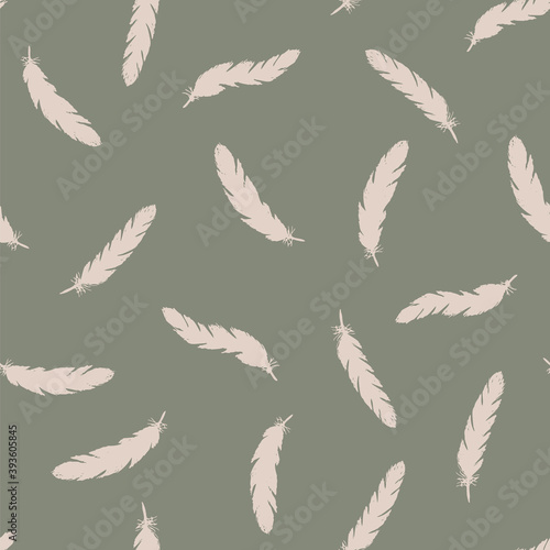 Pink feathers seamless pattern on green background.