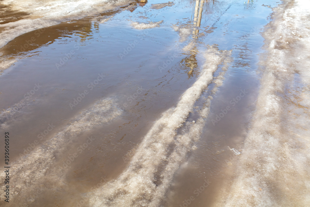 The road with melting snow in nature. The road with melting snow in nature.