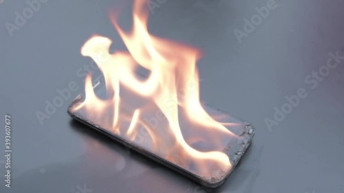 Mobile phone explodes and burns. Cell Phone explosion and fire .Smart Phone Danger from over use or bad manufacturing. Burning up my phone concept.