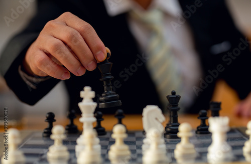 Businessman playing chess on board in office, strategy and competition Chess financial business strategy concept.