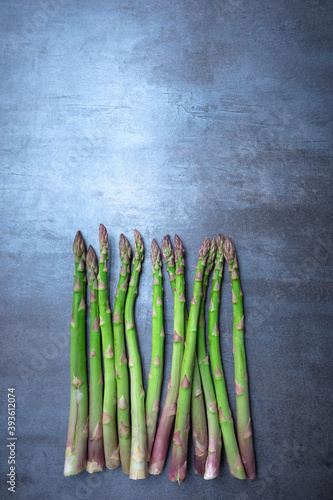 fresh green asparagus. Healthy eating concept. Food for vegetarians. Raw vegetables. Dark background. Free space for edits
