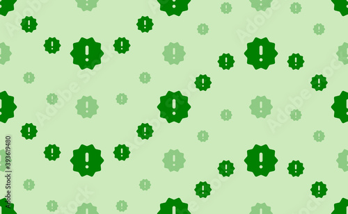 Seamless pattern of large and small green warning symbols. The elements are arranged in a wavy. Vector illustration on light green background