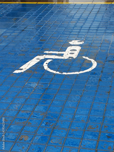traditional blue and white handicap sign in the pouring rain