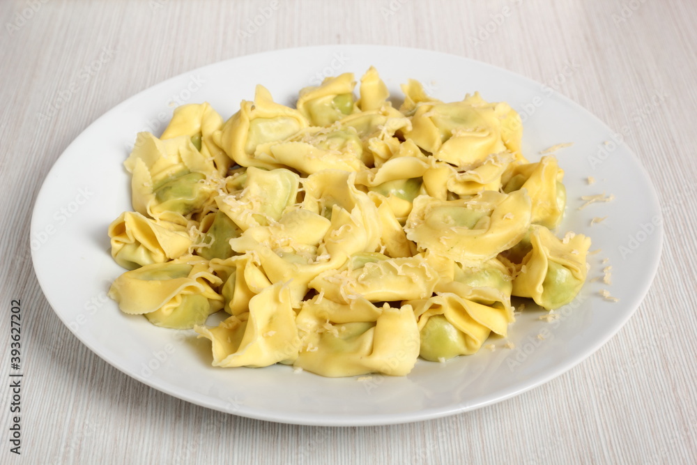 Tortellini stuffed with spinach and ricotta. Covered with grated cheese.