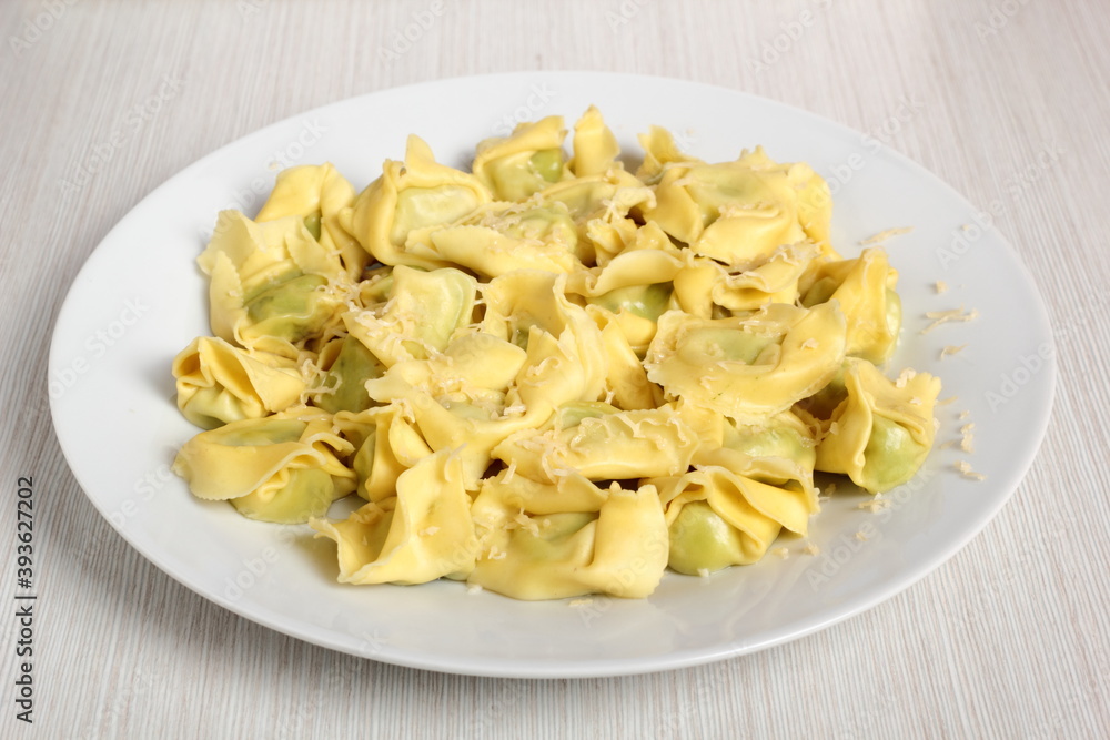 Tortellini stuffed with spinach and ricotta. Covered with grated cheese. Tortellini stuffed with spinach and ricotta. Covered with grated cheese.