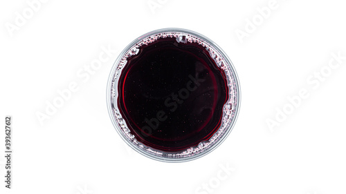 Cherry juice in a clear glass on a white background. View from the top. High quality photo