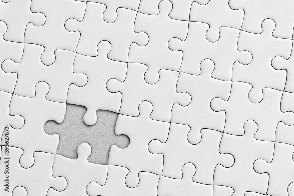 White jigsaw puzzle pattern background. placing last piece of jigsaw puzzle. White jigsaw puzzle pattern background. placing last piece of jigsaw puzzle.