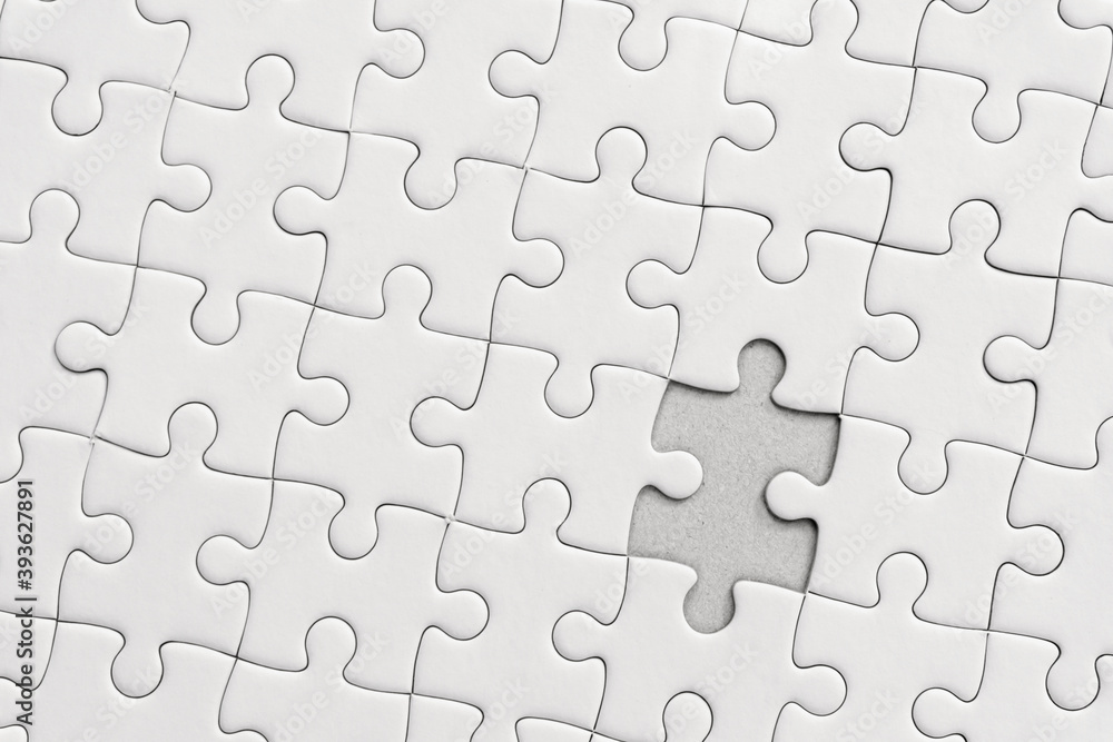 White jigsaw puzzle pattern background. placing last piece of jigsaw puzzle. White jigsaw puzzle pattern background. placing last piece of jigsaw puzzle.