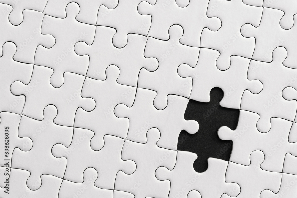 White jigsaw puzzle pattern background. placing last piece of jigsaw puzzle. White jigsaw puzzle pattern background. placing last piece of jigsaw puzzle.
