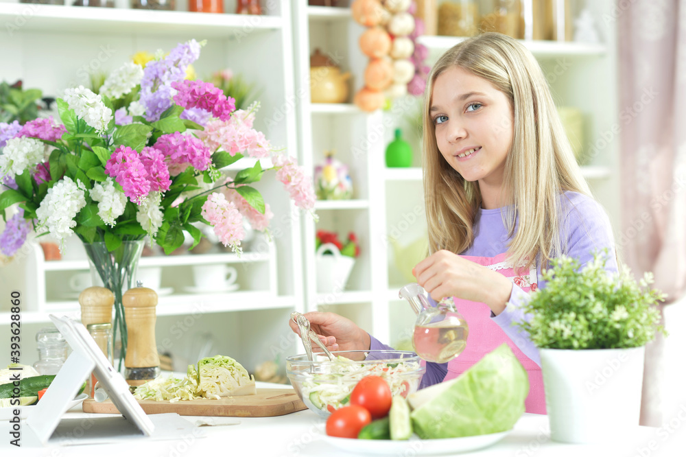 Cute little girl pouring oil in salad Cute little girl pouring oil in salad