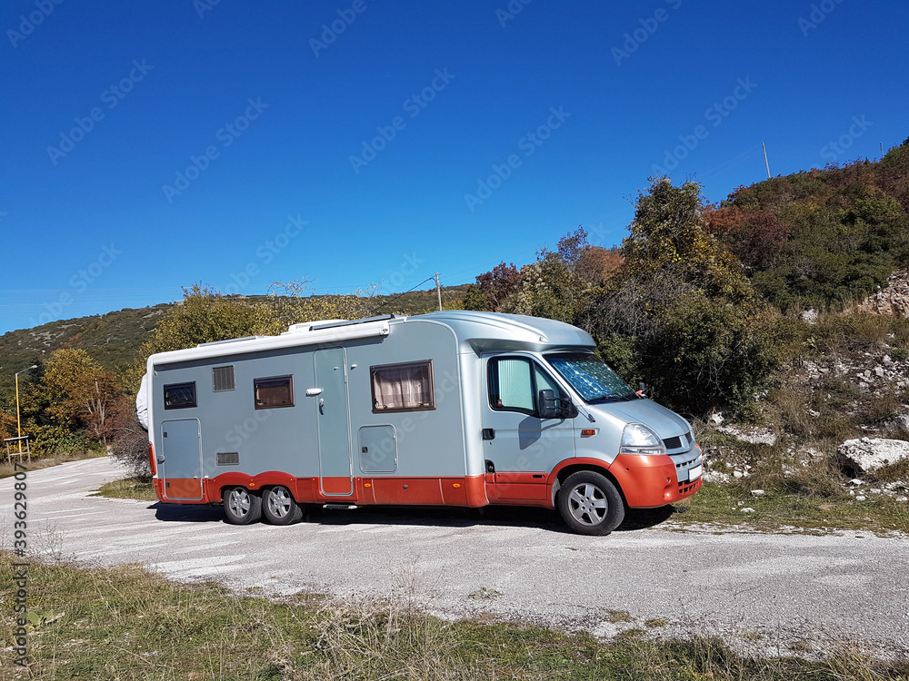 caravan car autumn in a forest sunny day