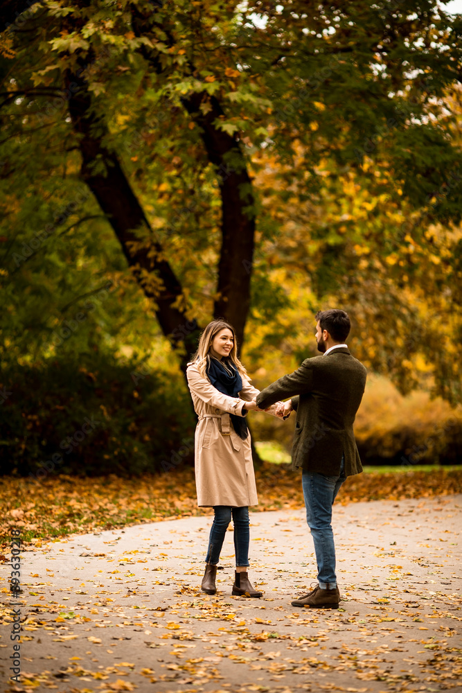 Fototapeta premium Young couple having fun in the autumn park