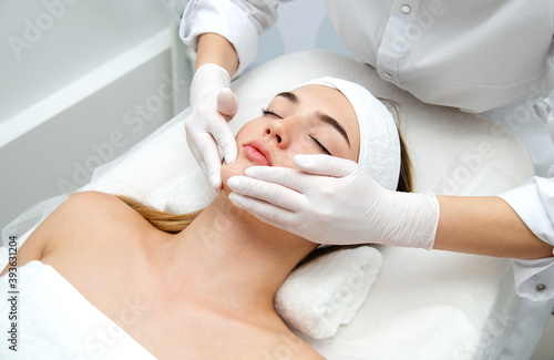 Woman getting face beauty treatment in medical spa center.