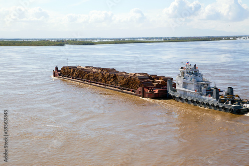 Canvas Print The barge transports timber along the river. Horizontally.
