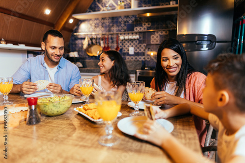 Latin family having dinner at home