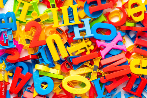 Heap of multicolored magnetic plastic letters, top view