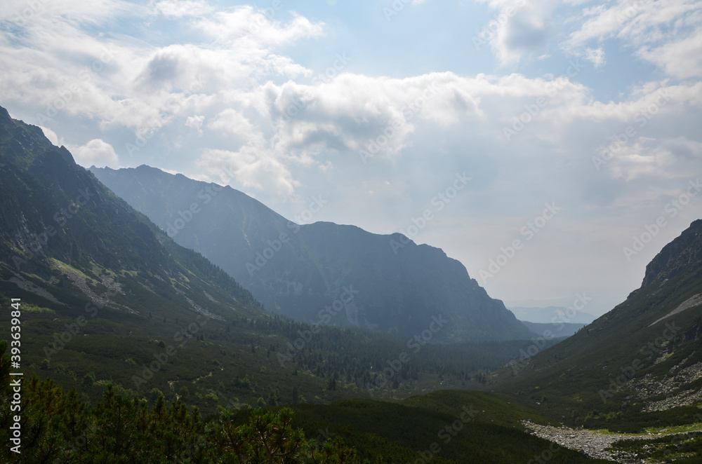 Obraz premium Foggy mountains landscape, hiking trail in Mengusovska valley, High Tatras (Vysoke Tatry), Slovakia