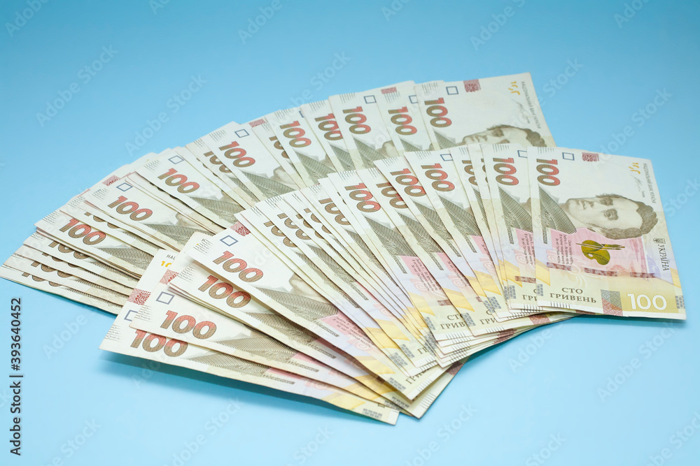 Ukrainian currency on a blue background. A pile of money. Hryvnia Ukrainian currency on a blue background. A pile of money. Hryvnia