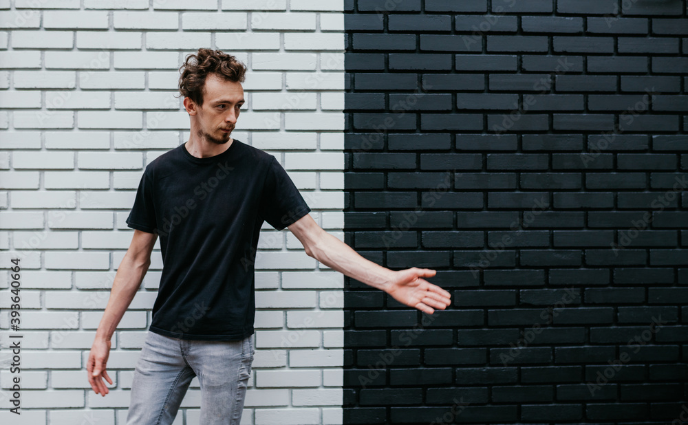 Young charismatic hipster guy wearing black blank t-shirt. Mock-up for print. T-shirt template. Young charismatic hipster guy wearing black blank t-shirt. Mock-up for print. T-shirt template.
