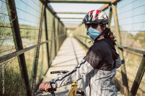 Biker with face mask training sport in pandemic time