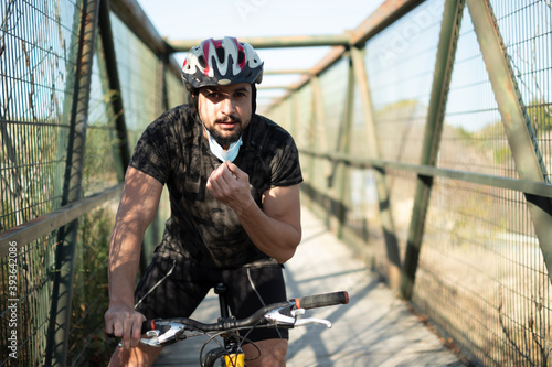 Biker with facemask training sport in pandemic time