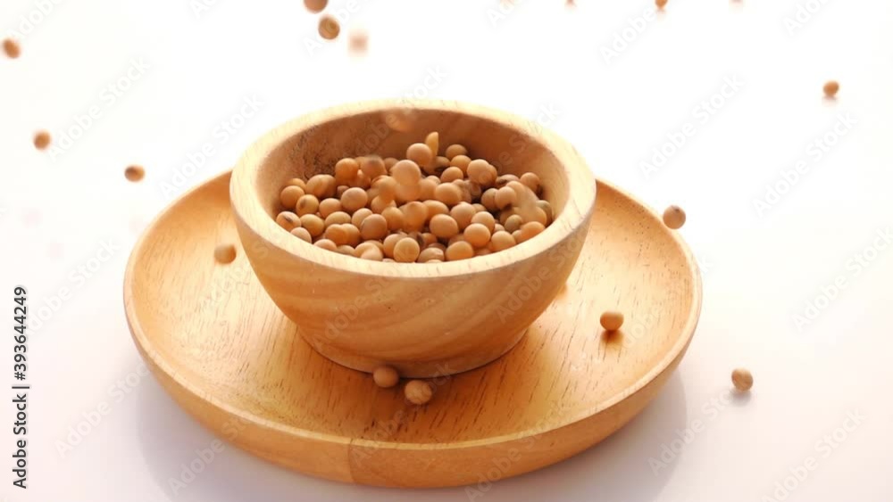 Slow Motion of Soybean Falling in wooden bowl on white background Slow Motion of Soybean Falling in wooden bowl on white background