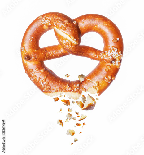 Bild auf Leinwand Freshly baked pretzel broken in the air on a white background