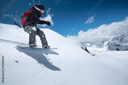 Woman snowboarder has fun riding on snowy off-road freeride in the Italian Alps. Professional sportswoman snowboard freeride