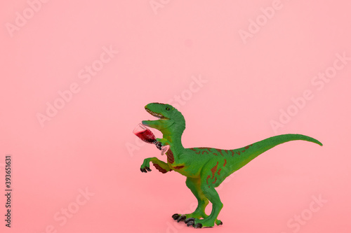 creative minimal poster with drunk dinosaur holding glass of wine on a pink background