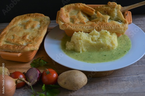 mash and pie london pie in the white plate on wooden table