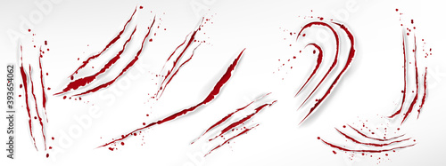 Cat claw scratches with blood drops, red torn slashes from wild animal, tiger, bear or lion paws isolated on white background. Vector realistic sharp talons marks, wounds with bloody splatter photo