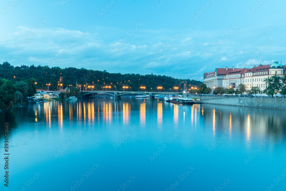 Vltava river with bridge in the dusk in Prague, Czech Republic.