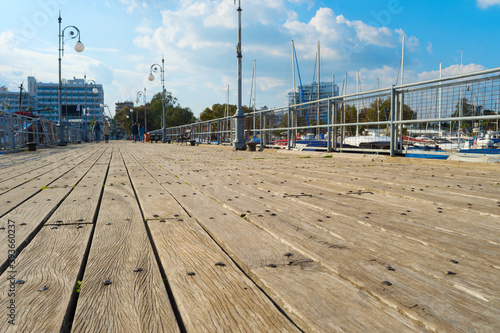 Wooden pier yachts people C...
