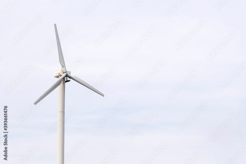 Windmill against a blue sky, generate energy from the wind Windmill against a blue sky, generate energy from the wind