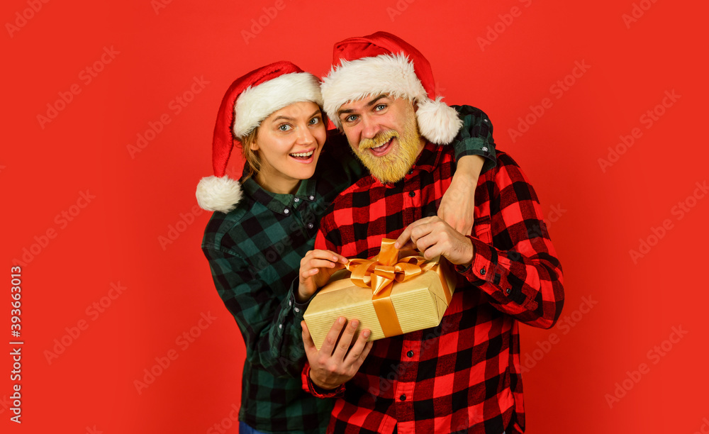 Couple in love with gift. Family shopping. Surprise for spouse. Buy present. Christmas party. Christmas time. Man and woman christmas holiday celebration. Giving present. Love and care. Spread love Couple in love with gift. Family shopping. Surprise for spouse. Buy present. Christmas party. Christmas time. Man and woman christmas holiday celebration. Giving present. Love and care. Spread love