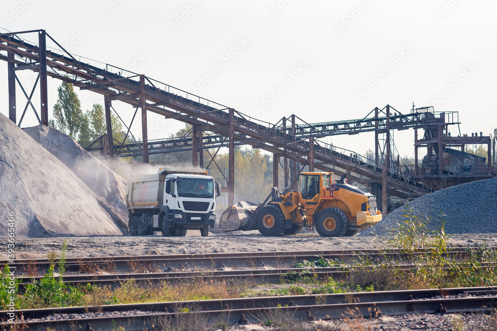 Gravel pit, loader loads gravel on a dump truck Gravel pit, loader loads gravel on a dump truck