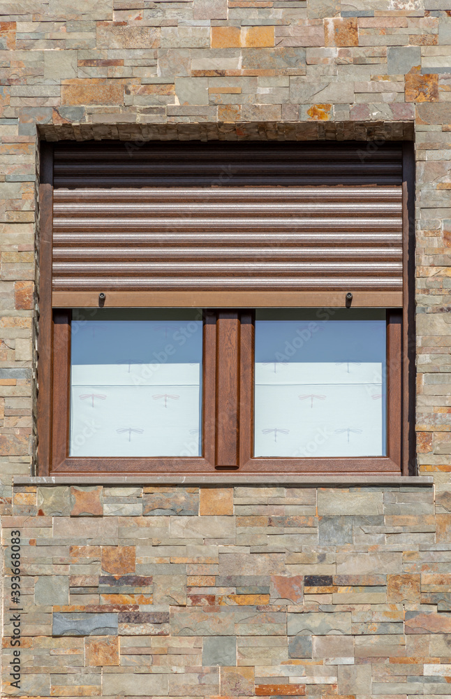 Wooden windows with open shutters on brick facade
