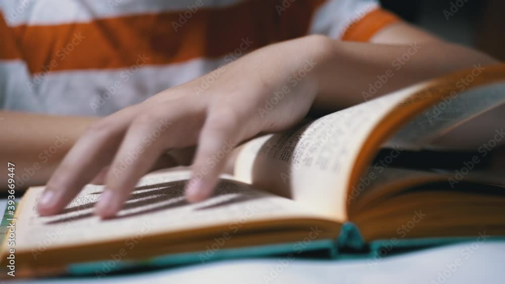 Hands Child Turning Page Book. Self-isolation of Children at Home. Reading Hands Child Turning Page Book. Self-isolation of Children at Home. Reading