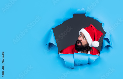 look over there. present and gift shopping sale. happy new year. merry christmas. cheerful bearded man in santa claus costume. brutal hipster celebrate xmas party. winter holiday preparations